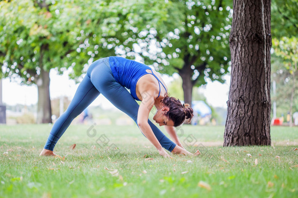 在公园练习<strong>瑜伽</strong>的年轻女子