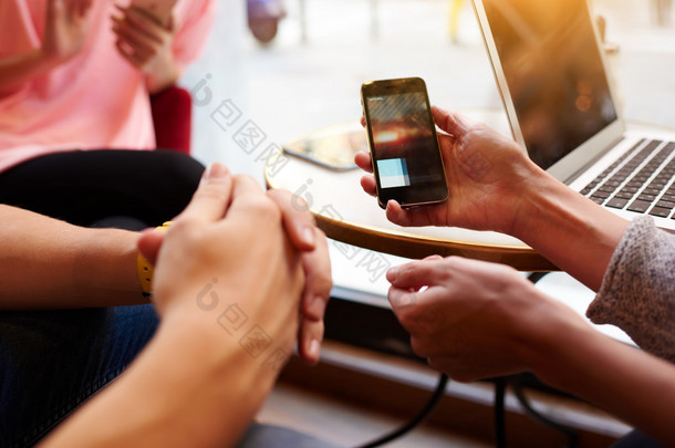 Closeup image of two person are watching video in internet via cellphone, while they are sitting in 