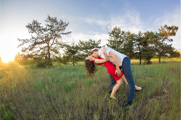 在公园里快乐的年轻夫妇怀抱