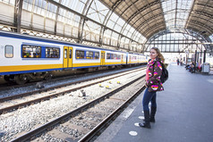 年轻女人等待 Amsterda 中央车站的列车