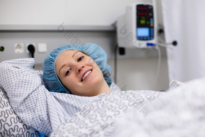 Young woman in hospital recovery room after surgery