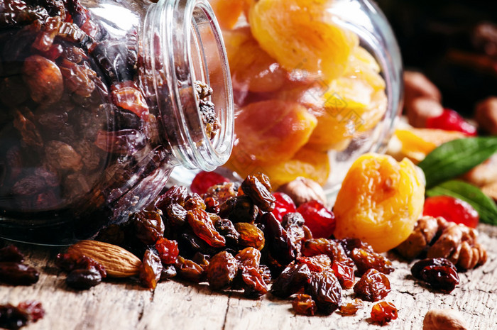 Dry dark raisins in a glass jar