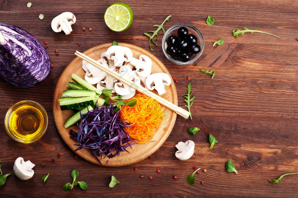 The concept of dietetic vegetarian food. Bright juicy shredded vegetables, such as carrots, purple c