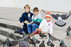 u00a0children feeding doves