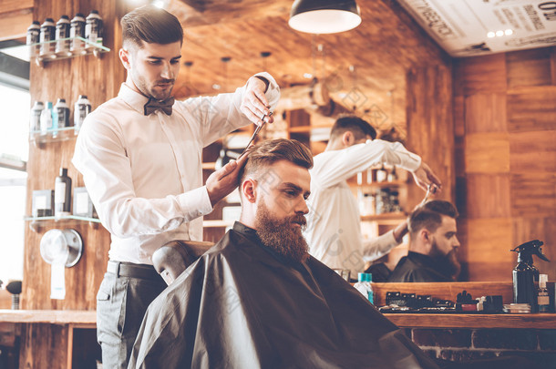 young bearded man with hairdresser