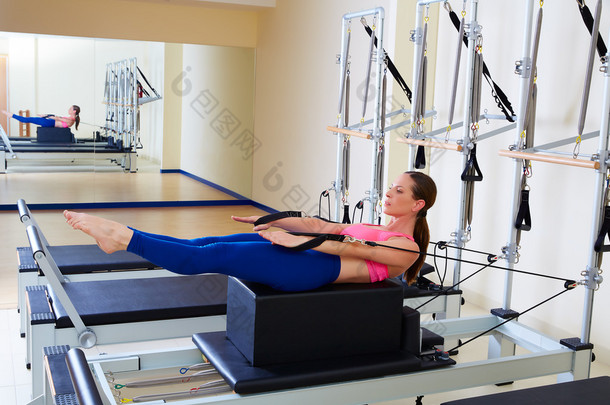 Pilates reformer woman back stroke exercise