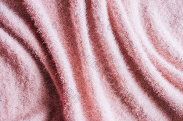 粉红色蓬松毛织物背景的全帧图像