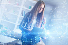 有吸引力的年轻欧洲女商人使用笔记本电脑与发光的外汇图表在办公室内部。成功和贸易理念。双重曝光 