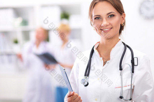 一位女大夫站在医院的文件夹