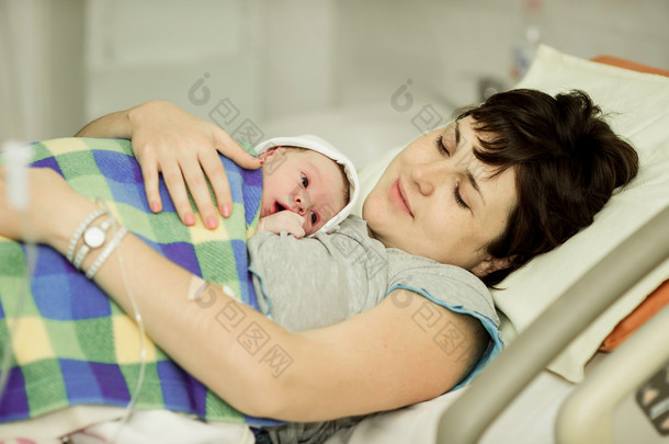 <strong>happy</strong> woman after birth with a newborn baby