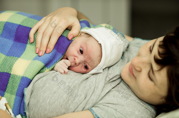 <strong>happy</strong> woman after birth with a newborn baby
