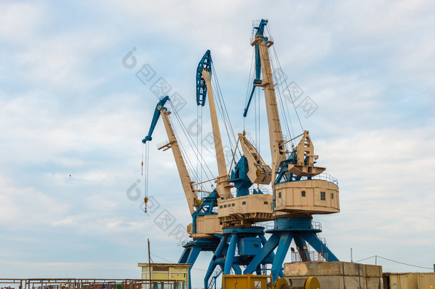 Port cranes on bright day