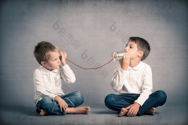 brothers talking with tin can telephone