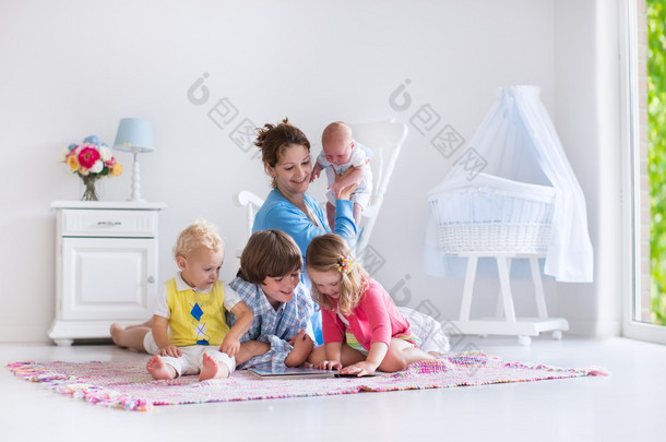 Mother and kids playing in bedroom