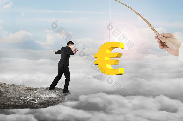 Man balancing golden euro symbol fishing lure with sun clouds