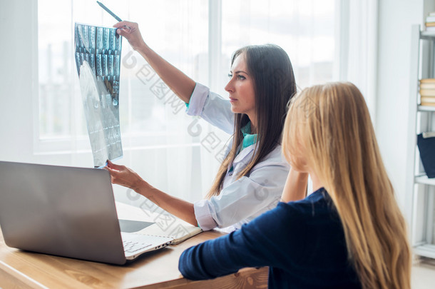 doctor and patient looking at x-ray or MRI concept healthcare, medical radiology concept.