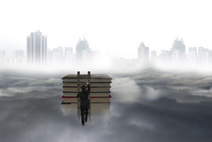 Business man climbing on wooden ladder to top of books