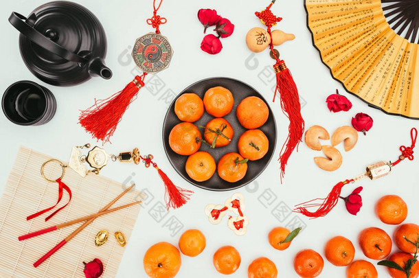 中国 talimans 与柑橘及茶叶分离的顶部视图白色, 中国新年概念
