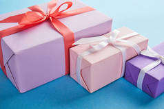 蓝色背景彩带和蝴蝶结的彩色礼品盒