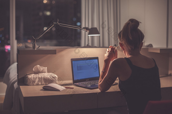 Young woman overworking in the office