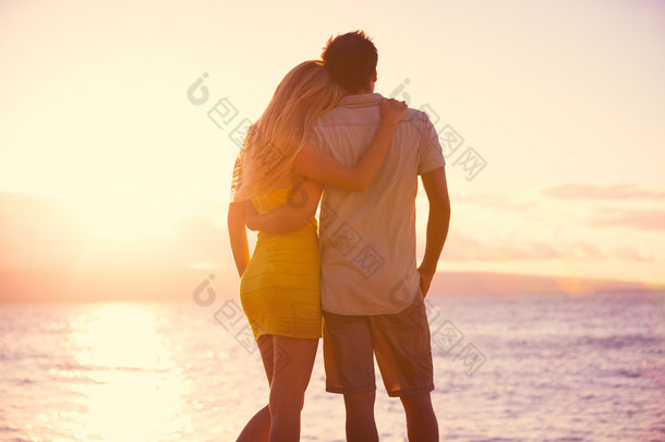 浪漫的情侣，在热带的海滩上看日落