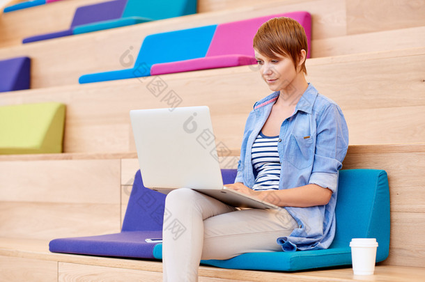 woman working on laptop in <strong>open</strong> interior