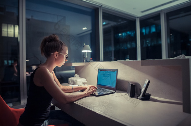 Young woman overworking in the office