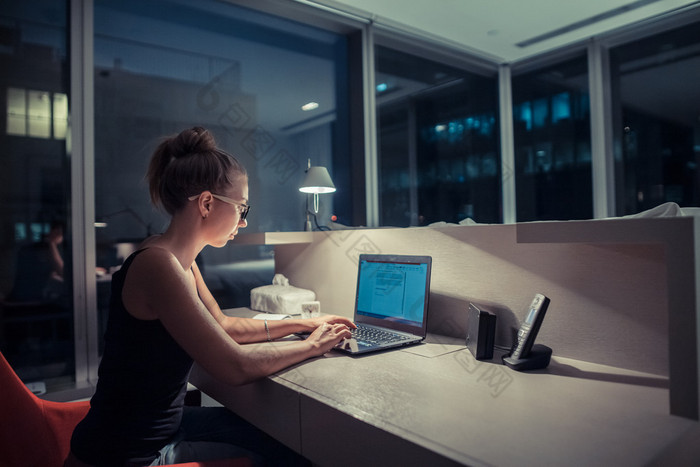 Young woman overworking in the office