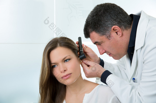 ENT医生用耳镜检查女病人的<strong>耳朵</strong>