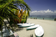 在晴朗的日子, 在白色沙滩上五颜六色的堆叠独木舟。蓝天和清澈的海水背景. 马来西亚 Kapas 岛 (棉花岛) 拍摄的照片