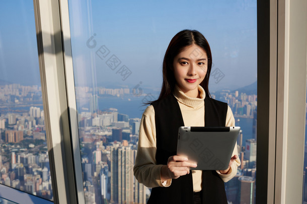 Young Asian woman is holding portable digital tablet