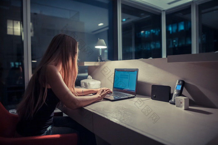 Young woman overworking in the office