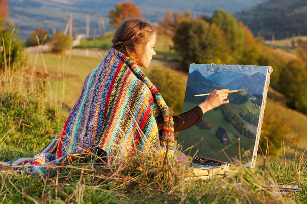 年轻的画家画着秋天的风景