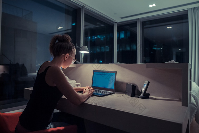 Young woman overworking in the office