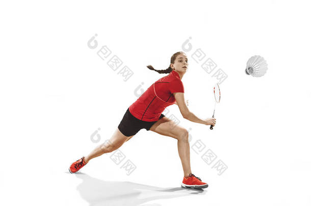 年轻女子在白色的背景<strong>打羽毛球</strong>