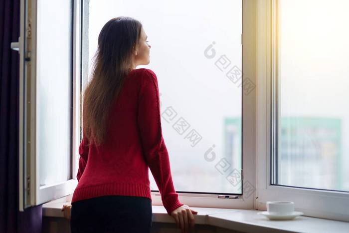 年轻女子打开窗户享受新鲜空气侧视图高清图片下载