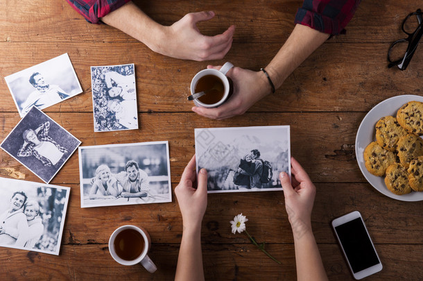 Mans and womans hands. Black-and-white photos. Couple. Tea, cookies, phone.