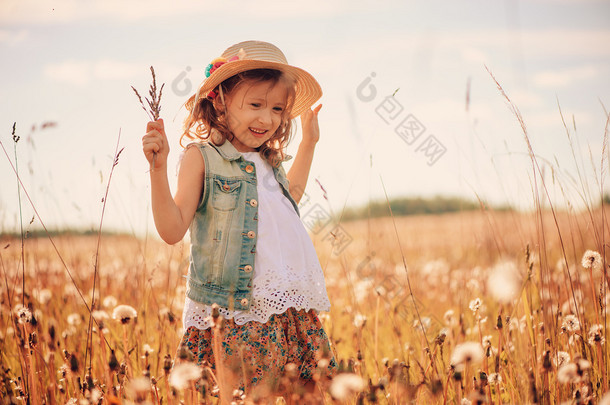 happy child on <strong>summer</strong> field, spending vacation outdoor, warm rural scene
