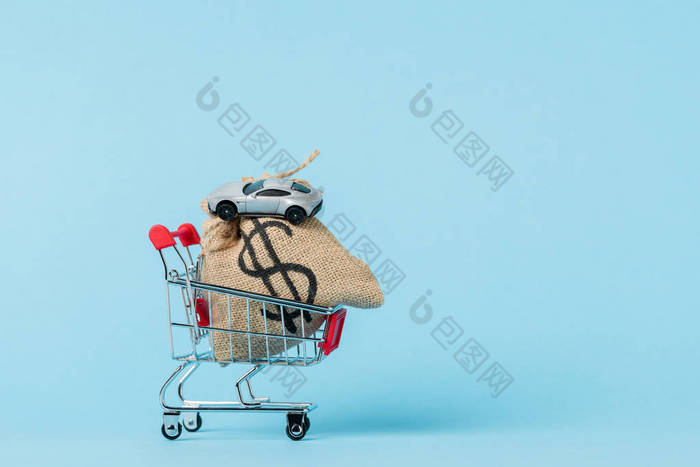 little shopping trolley with dollar bag and toy car on blue, leasing concept