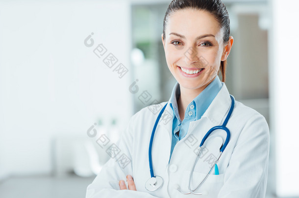 Confident female doctor posing in her office