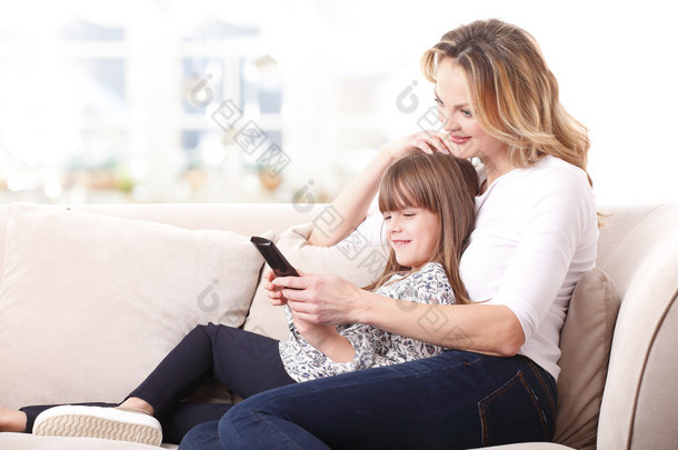 快乐的母亲和女儿看电视