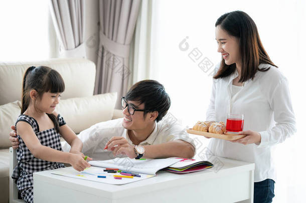 亚洲家庭在客厅里做作业