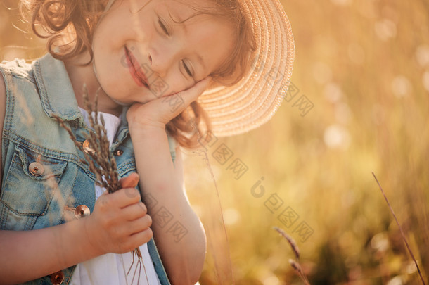 happy child on summer field, spending vacation outdoor, warm rural scene