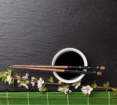 chopsticks, soy sauce and sakura blossom