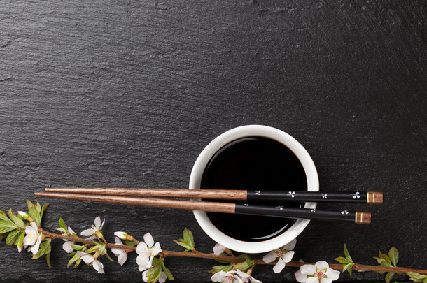 chopsticks, soy sauce and sakura blossom