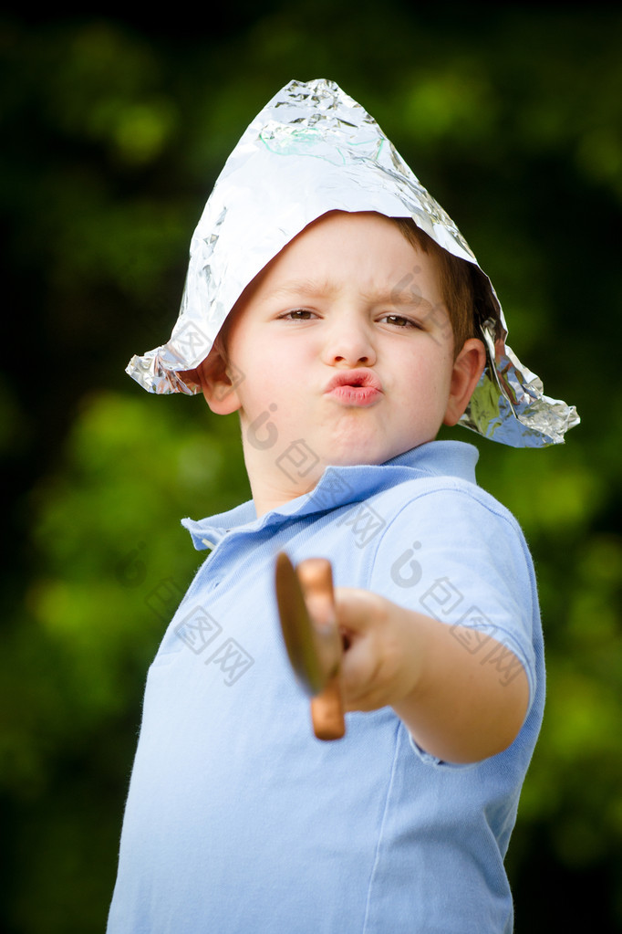 Child playing pirate outdoors in homemade costume