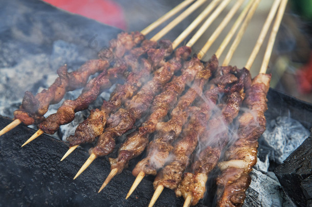 Delicious street food of Barbecued Lamb shish kebabs on the streets of Guilin, Guangxi Autonomous Re