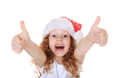 有趣的女孩，在圣诞老人的帽子在小雪背景上出现了，竖起大拇指