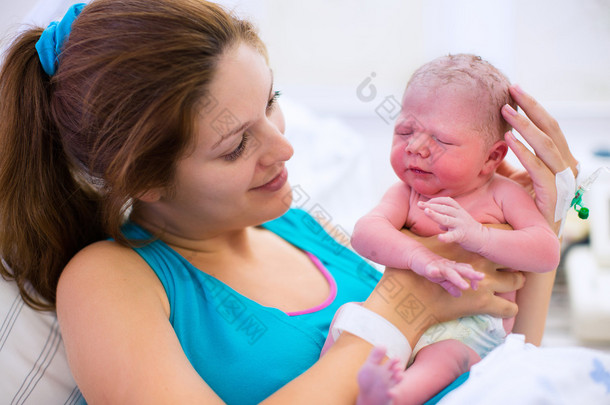 Young mother giving birth to a baby