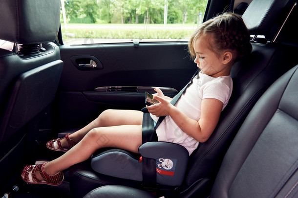 小女孩坐在一辆车上
